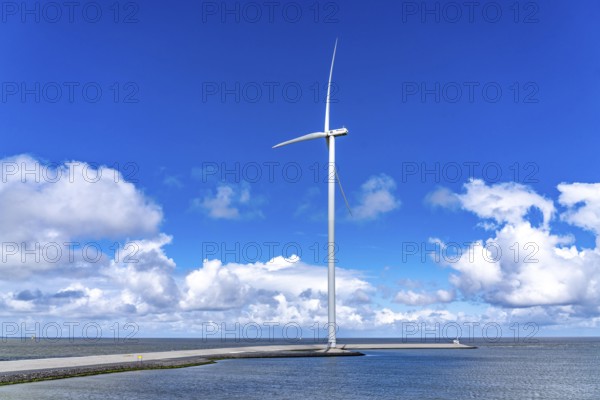 Strekdammen Wind Farm, wind farm at the seaport of Eemshaven in the Netherlands, built on offshore breakwaters, 2 GE Cypress 5, 5 MW turbines, with 158 metre blade diameter, together produce 11 MW of power, can supply 15, 500 households with electricity from wind, cumulus cloud over the North Sea, Netherlands