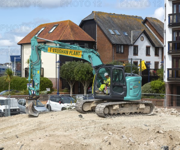 Kobelco long reach crawler tracked excavator vehicle on construction site, Millbank marina village, Plymouth, Devon, England, UK