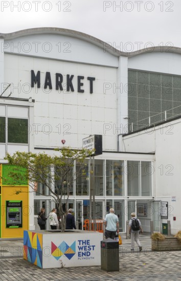 People at entrance door of Market Building or Pannier Market, city of Plymouth, Devon, England, UK