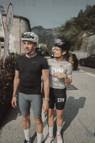 Woman and man riding racing bikes in Italy on Lake Garda