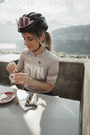 Young woman riding a racing bike on Lake Garda. Sunny weather and dolce vita