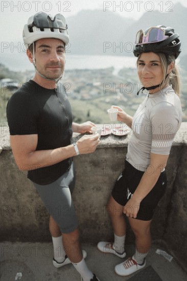 Young man taking a coffee break while riding his racing bike on Lake Garda. Sunny weather and dolce vita
