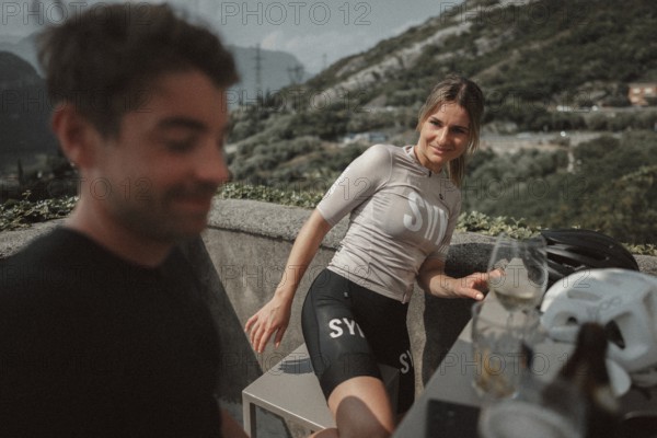 Young man taking a coffee break while riding his racing bike on Lake Garda. Sunny weather and dolce vita