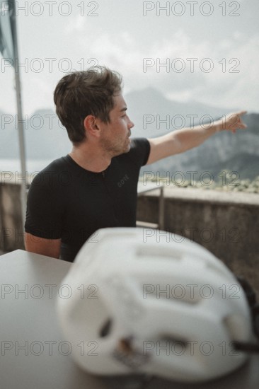 Young man riding a racing bike on Lake Garda. Sunny weather and dolce vita