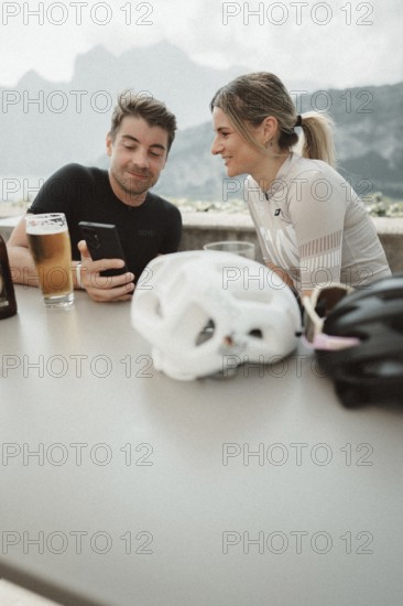 Woman and man cycling on Lake Garda in Italy. Sunny weather and dolce vita