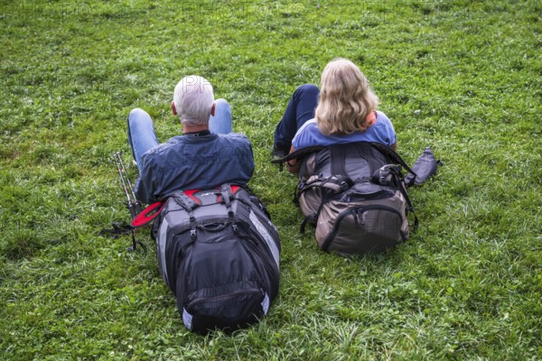 Couple resting in the grass, Interlaken, Bern, Switzerland