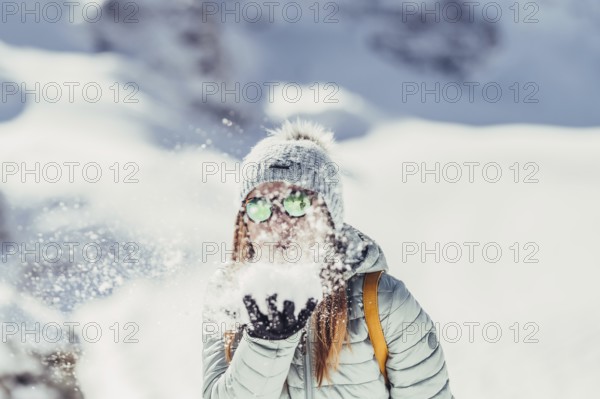 Woman in wintry surroundings in the Engadine in Switzerland