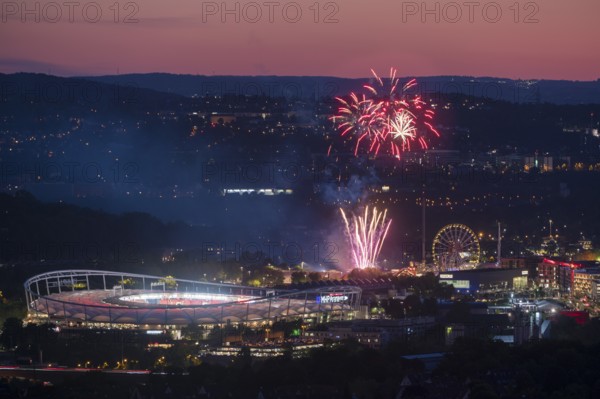 Fireworks at night illuminate the city above a stadium, next to an illuminated Ferris wheel in a hillside atmosphere, Spring Festival, MHP Arena, Bad Cannstatt, Stuttgart, Baden-Württemberg, Germany