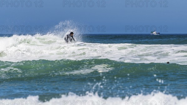 Surfer riding a wave on Contis beach, Saint Julien en Born, Saint-Julien-en-Born, Landes, France