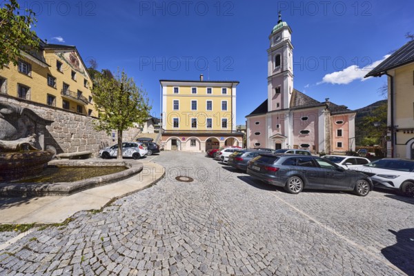 Town hall, St. Andreas, church, fountain at the town hall square, general architecture, quarry stone wall, car park, vehicles, trees, square, cobblestones, blue sky, cumulus clouds, town hall square, Berchtesgaden, Upper Bavaria, district Berchtesgadener Land, Bavaria, Germany