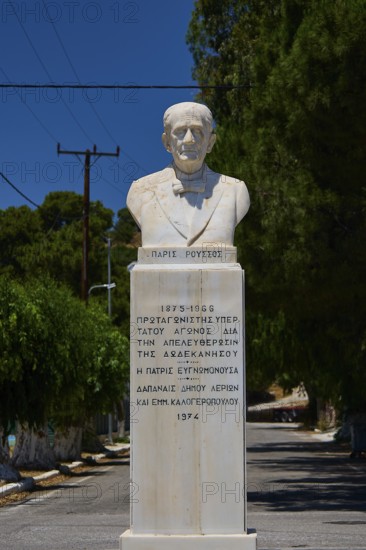 Paris Roussos, fighter for unification with Greece, marble bust on a pedestal with inscription, placed in a quiet street with trees, photos with reference to WW2, Battle of Leros, Leros, Dodecanese, Greek Islands, Greece