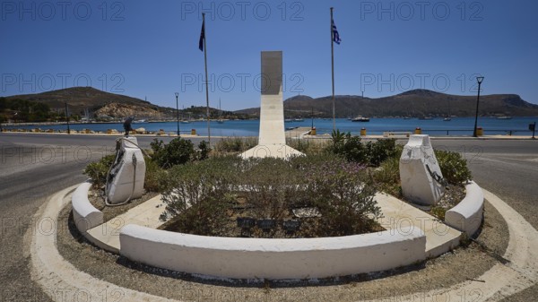 War memorial, circular memorial with sea view, surrounded by two flags and a mountainous background, photos related to WW2, Battle of Leros, Lakki, Leros, Dodecanese, Greek Islands, Greece
