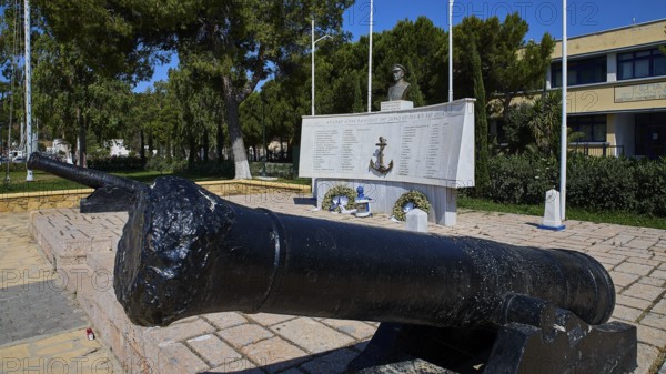 A monument with cannons and bust, surrounded by inscriptions and green vegetation in the open, photos related to WW2, Battle of Leros, Portolago, Lakki, Leros, Dodecanese, Greek Islands, Greece