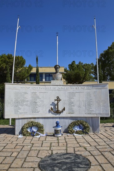 An open-air monument with bust and anchor, accompanied by plaques with inscriptions and wreaths, photos relating to WW2, Battle of Leros, Portolago, Lakki, Leros, Dodecanese, Greek Islands, Greece