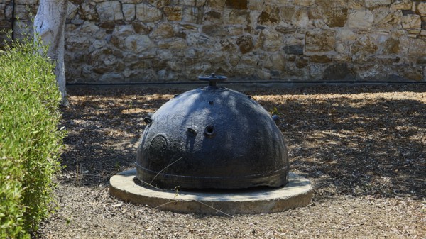 Bellini's Tower, Museum, An old black mine sits on a concrete foundation in front of a stone wall, Photos related to WW2, Battle of Leros, Alinda, Leros, Dodecanese, Greek Islands, Greece