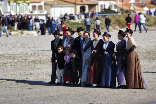 Group of pilgrims in traditional costumes, sandy beach, pilgrimage, Saintes-Maries-de-la-Mer, Camargue, France