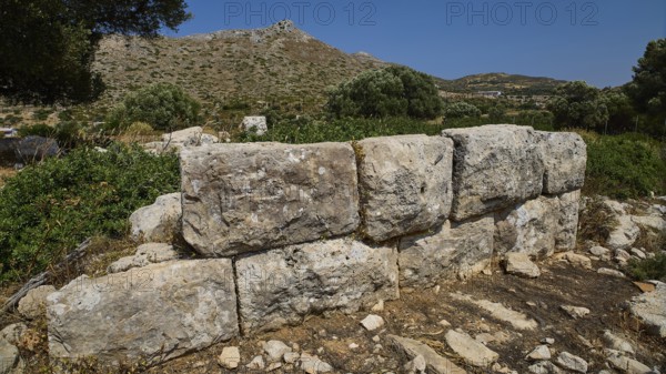 Monumental stone blocks form a wall in a mountainous, naturally beautiful setting, Artemis Temple, Artemis, Diana, goddess of the hunt, altar. Church, tower, near the airport in the north of the island, Leros, Dodecanese, Greek Islands, Greece