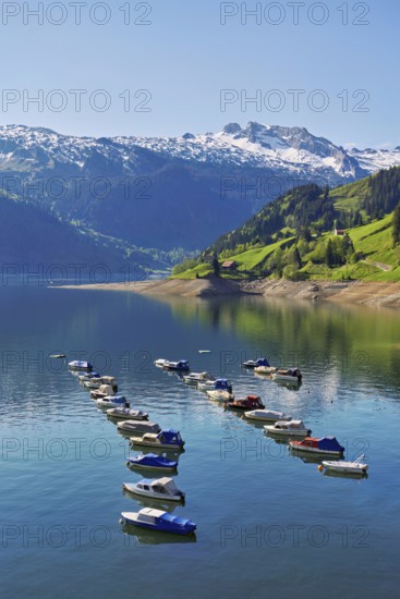 Motorboats moored at the reservoir, snow-covered Alps in the background, Lake Wägital, Canton Schwyz, Switzerland