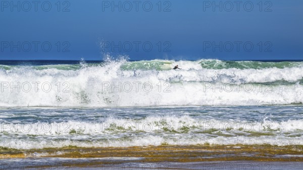 Surfer riding a wave on Contis beach, Saint Julien en Born, Saint-Julien-en-Born, Landes, France