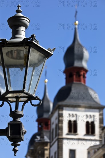 Historic alleyway lamp in front of the steeples of the Namen-Jesu-Kirche in Bonngasse, Bonn, North Rhine-Westphalia, Germany