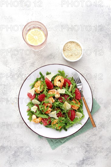 Fresh shrimp salad with arugula, grapefruit, and parmesan served in a bowl