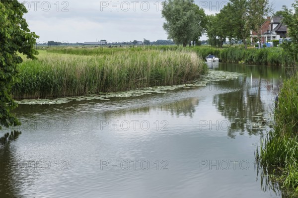 Damsterdiep canal in the village of ten Post, province of Groningen, Netherlands