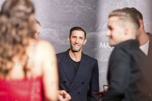 Marcel Remus between visitors at the Remus Lifestyle Night on 31 July 2025 on the roof terrace of the Pure Salt Hotel in Magaluf, Majorca, Spain