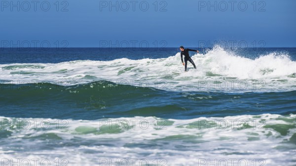 Surfer riding a wave on Contis beach, Saint Julien en Born, Saint-Julien-en-Born, Landes, France