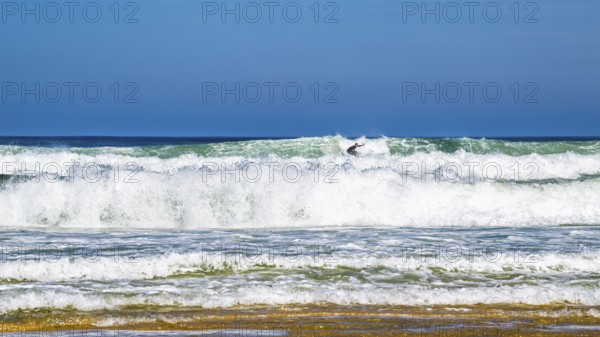 Surfer riding a wave on Contis beach, Saint Julien en Born, Saint-Julien-en-Born, Landes, France