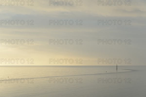 Wadden Sea at rising water, stone groyne with sea mark, North Sea, Norddeich, Lower Saxony, Germany
