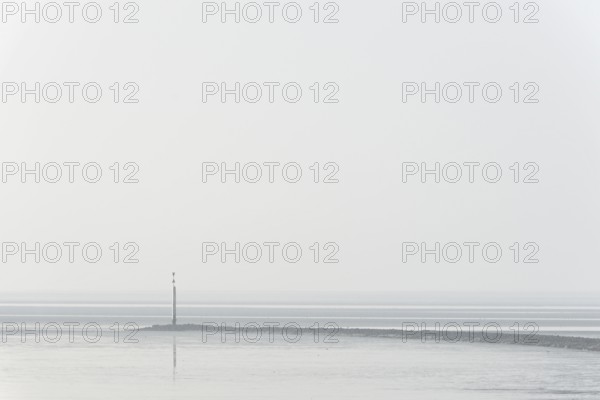 North Sea coast, cloudy winter day, Wadden Sea at low tide, stone groyne with sea mark, North Sea, Norddeich, Lower Saxony, Germany