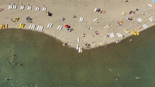 Aerial view of people relaxing on the beach. Sunbathing on the seashore