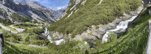 Panoramic view of the southern ascent to the descent from the Stelvio Pass Alpine pass, with the Cascata dello del Braulio waterfall on the right in front, Valdidentro, Lombardy, Italy