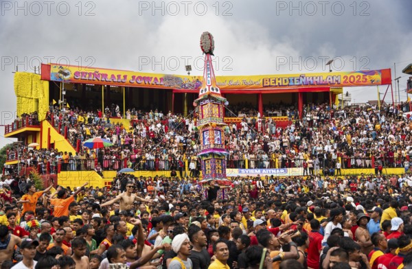 JOWAI, INDIA - JULY 14: People from the Pnar community march in a circle around a Rot as they celebrate an event organised to mark the Behdienkhlam festival in Jowai, India on July 14, 2025. Behdienkhlam is a vibrant annual festival celebrated by the Pnar (Jaintia) community of Meghalaya, especially in Jowai, to drive away plague and diseases and to pray for a good harvest. Observed in July after the sowing season, it features traditional rituals, offerings to ancestral spirits, and the grand procession of beautifully decorated bamboo structures called rots, which are later immersed in a sacred muddy pool known as Ka Aitnar