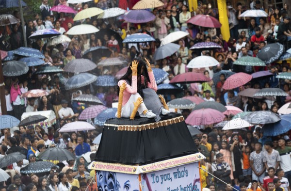 People from the Pnar community move around a Rot themed stop women harrasment as they celebrate an event organised to mark the Behdienkhlam festival in Jowai, India on July 14, 2025. Behdienkhlam is a vibrant annual festival celebrated by the Pnar (Jaintia) community of Meghalaya, especially in Jowai, to drive away plague and diseases and to pray for a good harvest. Observed in July after the sowing season, it features traditional rituals, offerings to ancestral spirits, and the grand procession of beautifully decorated bamboo structures called rots, which are later immersed in a sacred muddy pool known as Ka Aitnar