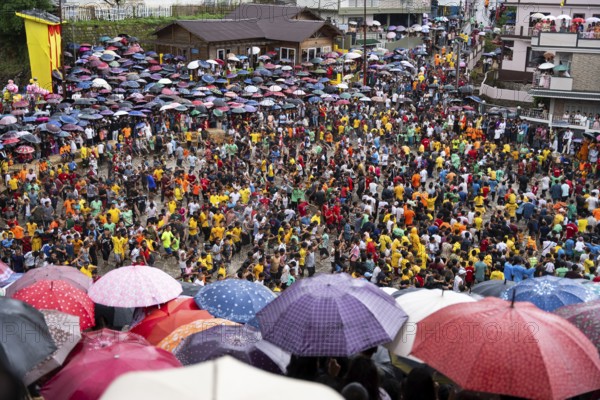 JOWAI, INDIA - JULY 14: People from the Pnar community march in a circle as they celebrate an event organized to mark the Behdienkhlam festival in Jowai, India on July 14, 2025. Behdienkhlam is a vibrant annual festival celebrated by the Pnar (Jaintia) community of Meghalaya, especially in Jowai, to drive away plague and diseases and to pray for a good harvest. Observed in July after the sowing season, it features traditional rituals, offerings to ancestral spirits, and the grand procession of beautifully decorated bamboo structures called rots, which are later immersed in a sacred muddy pool known as Ka Aitnar