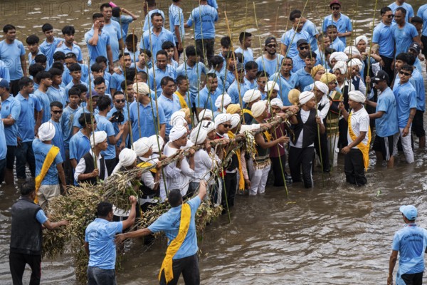 People from the Pnar community perform rituals as they using a tree to celebrate an event organised to mark the Behdienkhlam festival in Jowai, India on July 14, 2025. Behdienkhlam is a vibrant annual festival celebrated by the Pnar (Jaintia) community of Meghalaya, especially in Jowai, to drive away plague and diseases and to pray for a good harvest. Observed in July after the sowing season, it features traditional rituals, offerings to ancestral spirits, and the grand procession of beautifully decorated bamboo structures called rots, which are later immersed in a sacred muddy pool known as Ka Aitnar