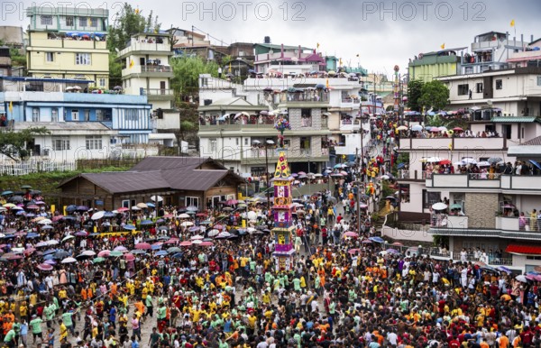 People from the Pnar community march in a circle around a Rot as they celebrate an event organised to mark the Behdienkhlam festival in Jowai, India on July 14, 2025. Behdienkhlam is a vibrant annual festival celebrated by the Pnar (Jaintia) community of Meghalaya, especially in Jowai, to drive away plague and diseases and to pray for a good harvest. Observed in July after the sowing season, it features traditional rituals, offerings to ancestral spirits, and the grand procession of beautifully decorated bamboo structures called rots, which are later immersed in a sacred muddy pool known as Ka Aitnar