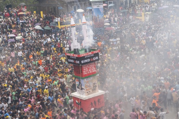 People from the Pnar community move around a Rot themed Operation Sindoor as they celebrate an event organised to mark the Behdienkhlam festival in Jowai, India on July 14, 2025. Behdienkhlam is a vibrant annual festival celebrated by the Pnar (Jaintia) community of Meghalaya, especially in Jowai, to drive away plague and diseases and to pray for a good harvest. Observed in July after the sowing season, it features traditional rituals, offerings to ancestral spirits, and the grand procession of beautifully decorated bamboo structures called rots, which are later immersed in a sacred muddy pool known as Ka Aitnar