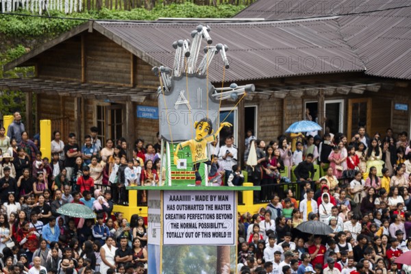 People from the Pnar community move around a Rot themed AI technology as they celebrate an event organised to mark the Behdienkhlam festival in Jowai, India on July 14, 2025. Behdienkhlam is a vibrant annual festival celebrated by the Pnar (Jaintia) community of Meghalaya, especially in Jowai, to drive away plague and diseases and to pray for a good harvest. Observed in July after the sowing season, it features traditional rituals, offerings to ancestral spirits, and the grand procession of beautifully decorated bamboo structures called rots, which are later immersed in a sacred muddy pool known as Ka Aitnar