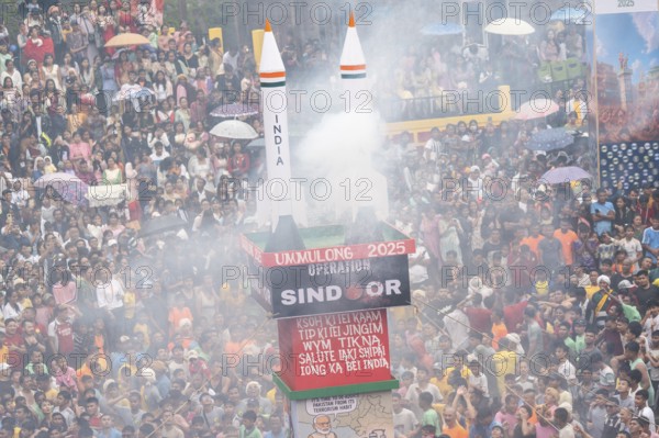 JOWAI, INDIA - JULY 14: People from the Pnar community move around a Rot themed Operation Sindoor as they celebrate an event organised to mark the Behdienkhlam festival in Jowai, India on July 14, 2025. Behdienkhlam is a vibrant annual festival celebrated by the Pnar (Jaintia) community of Meghalaya, especially in Jowai, to drive away plague and diseases and to pray for a good harvest. Observed in July after the sowing season, it features traditional rituals, offerings to ancestral spirits, and the grand procession of beautifully decorated bamboo structures called rots, which are later immersed in a sacred muddy pool known as Ka Aitnar
