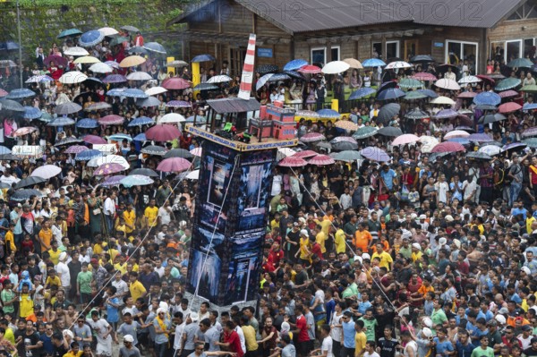 People from the Pnar community move around a Rot themed Coal Factory as they celebrate an event organised to mark the Behdienkhlam festival in Jowai, India on July 14, 2025. Behdienkhlam is a vibrant annual festival celebrated by the Pnar (Jaintia) community of Meghalaya, especially in Jowai, to drive away plague and diseases and to pray for a good harvest. Observed in July after the sowing season, it features traditional rituals, offerings to ancestral spirits, and the grand procession of beautifully decorated bamboo structures called rots, which are later immersed in a sacred muddy pool known as Ka Aitnar