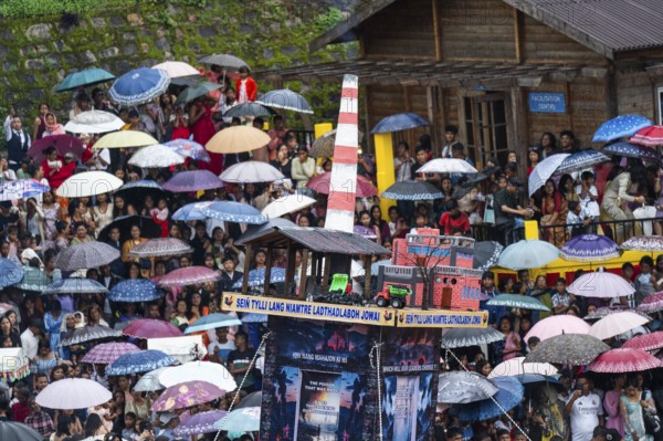 JOWAI, INDIA - JULY 14: People from the Pnar community move around a Rot themed Coal Factory as they celebrate an event organised to mark the Behdienkhlam festival in Jowai, India on July 14, 2025. Behdienkhlam is a vibrant annual festival celebrated by the Pnar (Jaintia) community of Meghalaya, especially in Jowai, to drive away plague and diseases and to pray for a good harvest. Observed in July after the sowing season, it features traditional rituals, offerings to ancestral spirits, and the grand procession of beautifully decorated bamboo structures called rots, which are later immersed in a sacred muddy pool known as Ka Aitnar