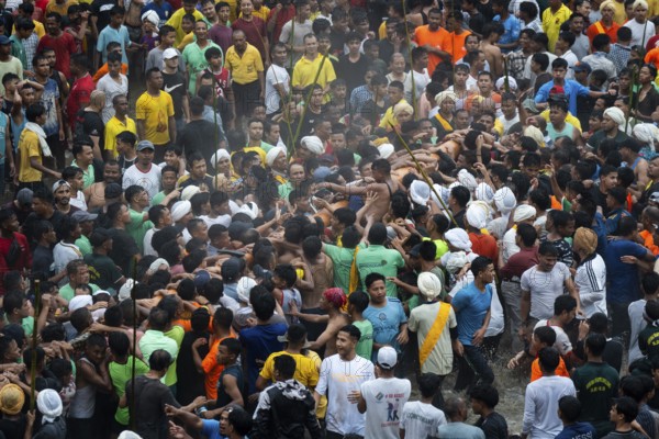 JOWAI, INDIA - JULY 14: People from the Pnar community perform rituals as they carry a large log to celebrate an event organised to mark the Behdienkhlam festival in Jowai, India on July 14, 2025. Behdienkhlam is a vibrant annual festival celebrated by the Pnar (Jaintia) community of Meghalaya, especially in Jowai, to drive away plague and diseases and to pray for a good harvest. Observed in July after the sowing season, it features traditional rituals, offerings to ancestral spirits, and the grand procession of beautifully decorated bamboo structures called rots, which are later immersed in a sacred muddy pool known as Ka Aitnar