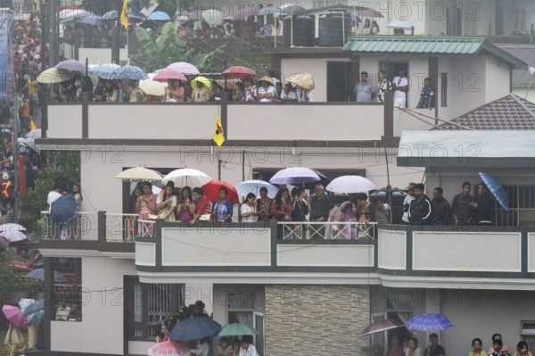 JOWAI, INDIA - JULY 14: People from the Pnar community emjoy the Behdienkhlam festival from rooftop in Jowai, India on July 14, 2025. Behdienkhlam is a vibrant annual festival celebrated by the Pnar (Jaintia) community of Meghalaya, especially in Jowai, to drive away plague and diseases and to pray for a good harvest. Observed in July after the sowing season, it features traditional rituals, offerings to ancestral spirits, and the grand procession of beautifully decorated bamboo structures called rots, which are later immersed in a sacred muddy pool known as Ka Aitnar