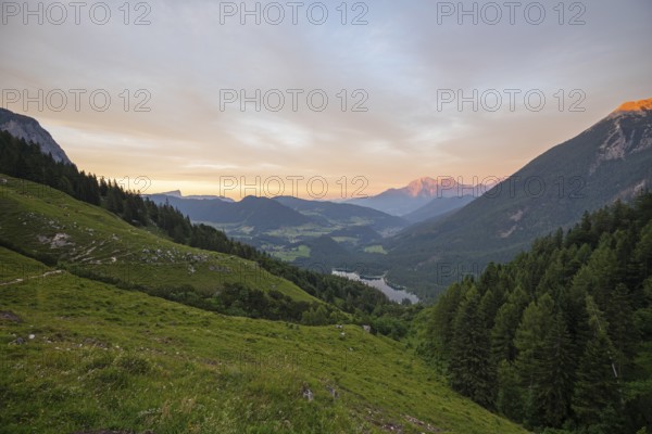 Magical sunset at the Halsalm above the Hintersee with views of the Hoher Göll, Hochkalter and Untersberg mountains