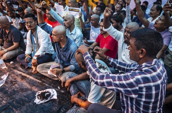 Drivers affiliated with Ola, Uber, and Rapido, under the banner of the Assam State Drivers' Union and the All Assam Cab Welfare Federation, shaved their heads in protest in Guwahati, India, on July 22, 2025. The demonstration held to highlight their demands for fair fare rates, regulation of aggregator commissions, and access to social security and welfare benefits