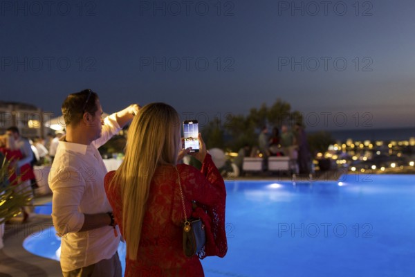 Guests photograph the evening sky at the Remus Lifestyle Night on the rooftop terrace of the Pure Salt Hotel in El Toro, Magaluf, Majorca, Spain on 31/07/2025