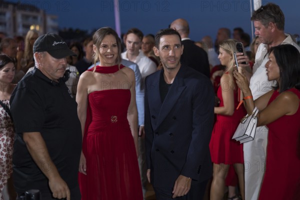 Hilary Swank and Marcel Remus walk through the crowd at the Remus Lifestyle Night on the rooftop terrace of the Pure Salt Hotel in El Toro, Magaluf, Majorca, Spain on 31/07/2025