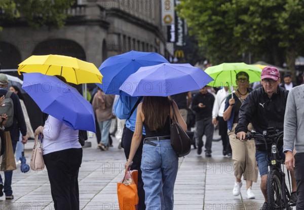 Rainy weather in Stuttgart. People with umbrellas hurry through the rain on Königstraße. Stuttgart, Baden-Württemberg, Germany